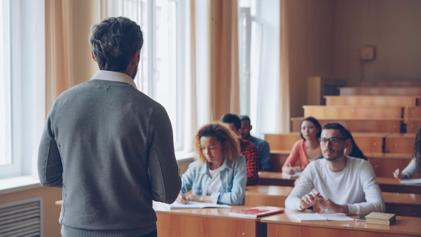 A professor teaching in a lecture hall
