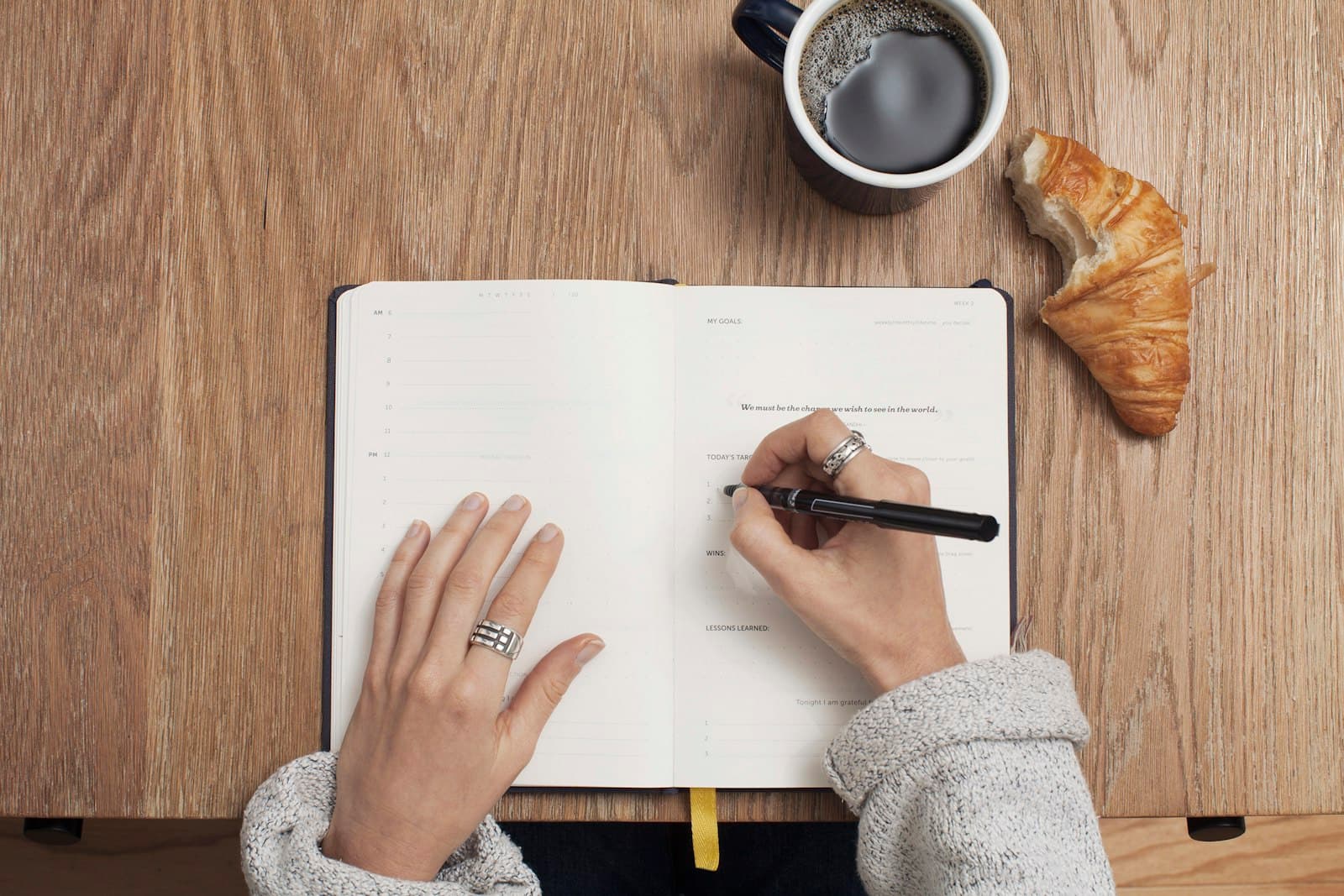 A researcher writing notes at a desk